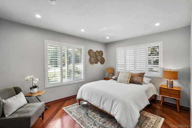 bedroom featuring dark hardwood / wood-style floors and multiple windows