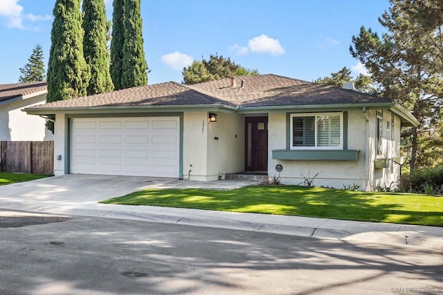 single story home with a front yard and a garage