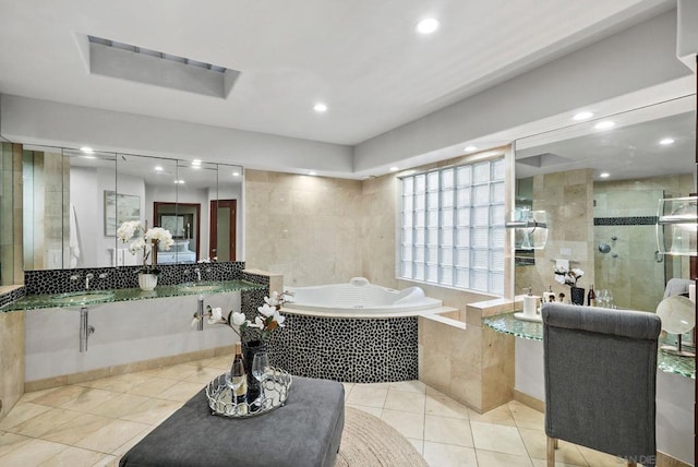 bathroom featuring sink, plus walk in shower, and tile patterned flooring