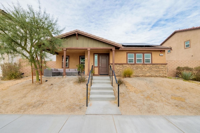 view of front of house with an outdoor hangout area, central AC, and solar panels