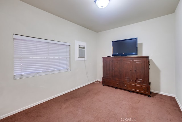 unfurnished bedroom featuring light carpet and an AC wall unit