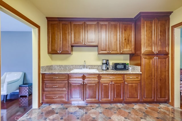 kitchen with sink and light stone counters