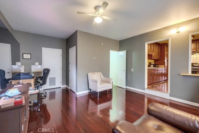 office area with ceiling fan and dark hardwood / wood-style flooring