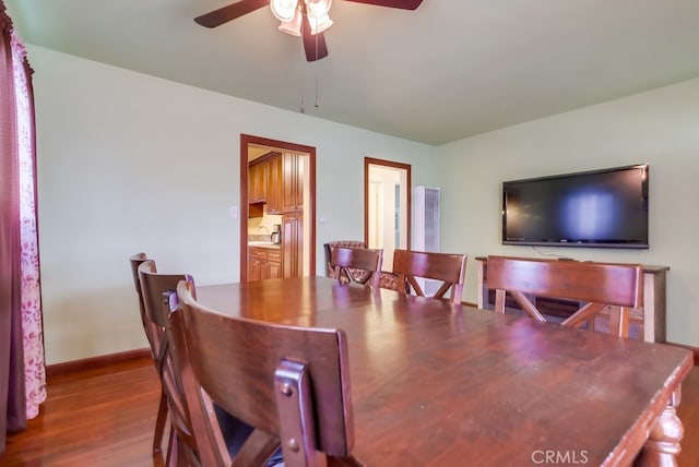 dining space featuring ceiling fan, sink, and hardwood / wood-style floors