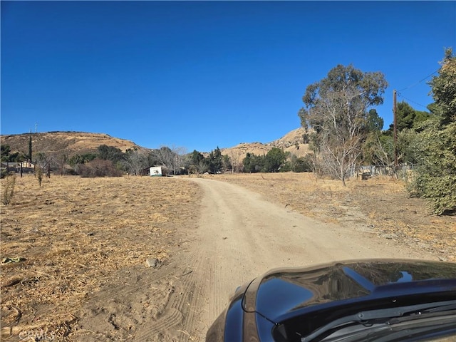 view of road featuring a mountain view and a rural view