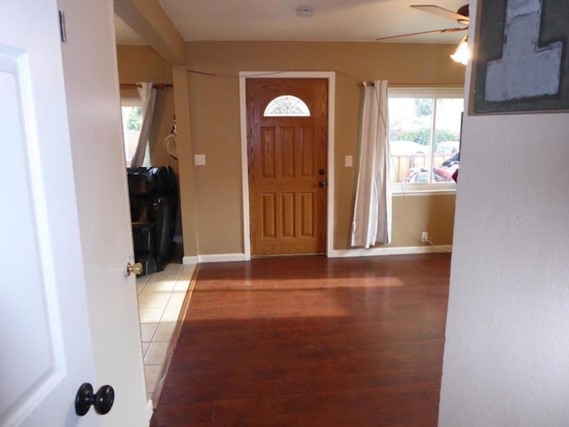 entryway with dark wood-type flooring and ceiling fan