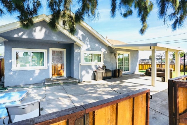 back of property featuring a patio area and outdoor lounge area