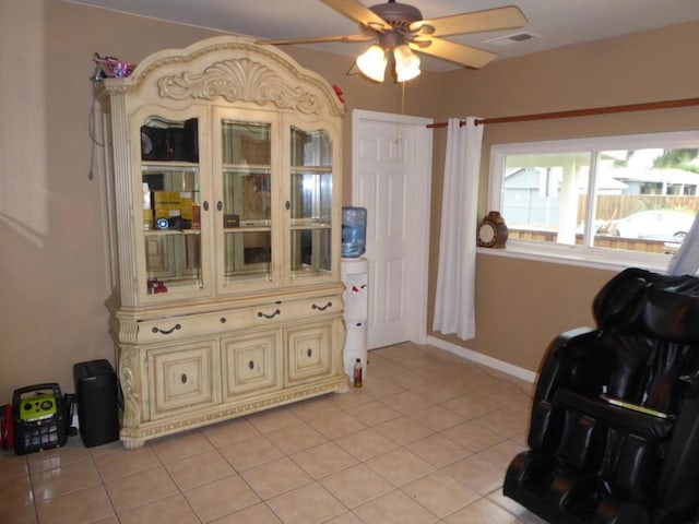 living area featuring ceiling fan and light tile patterned floors