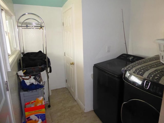 laundry room featuring separate washer and dryer and light tile patterned flooring