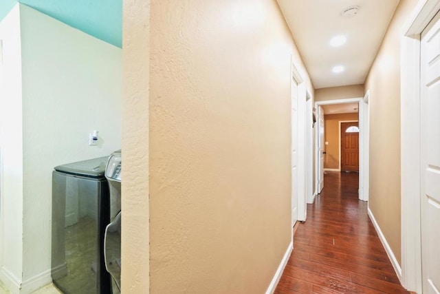 hall with washer / dryer and dark hardwood / wood-style flooring