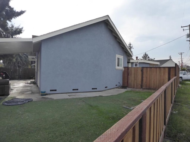 view of side of home with a lawn