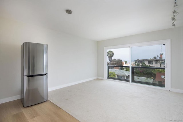 unfurnished living room featuring light carpet