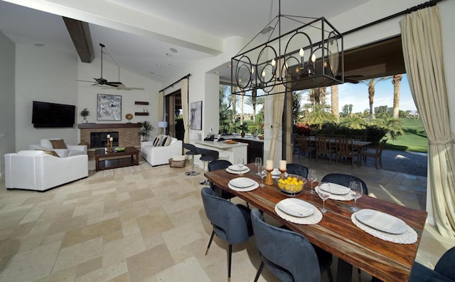 dining area featuring ceiling fan and lofted ceiling with beams