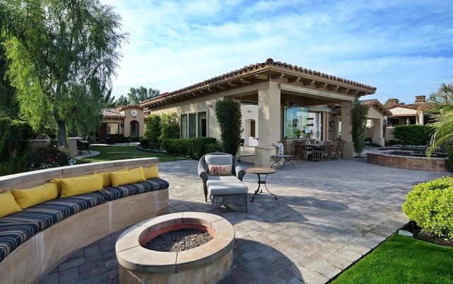 view of patio / terrace with an outdoor living space with a fire pit