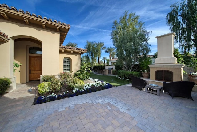 view of patio / terrace with exterior fireplace