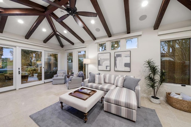 living room featuring ceiling fan, a healthy amount of sunlight, and vaulted ceiling with beams