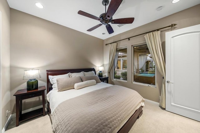 bedroom featuring light carpet and ceiling fan