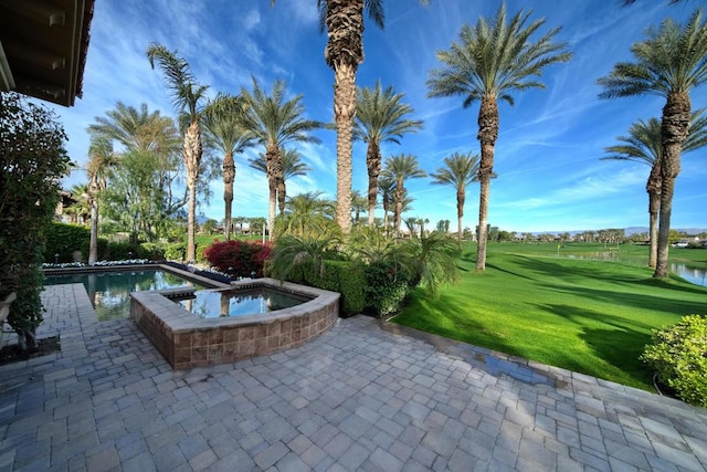 exterior space with an in ground hot tub, a yard, and a patio