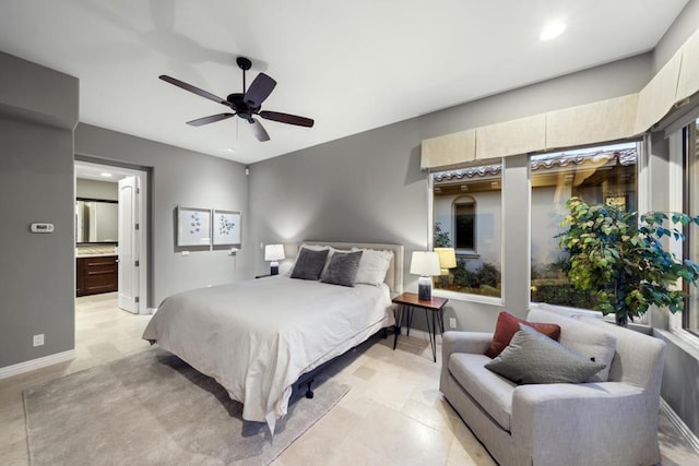 bedroom with ceiling fan and ensuite bath