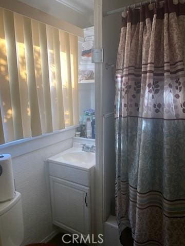 bathroom featuring vanity and shower / tub combo with curtain