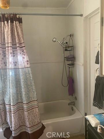 bathroom with shower / bath combo with shower curtain