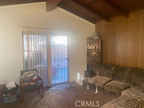 carpeted living room featuring vaulted ceiling with beams, wood ceiling, and wood walls