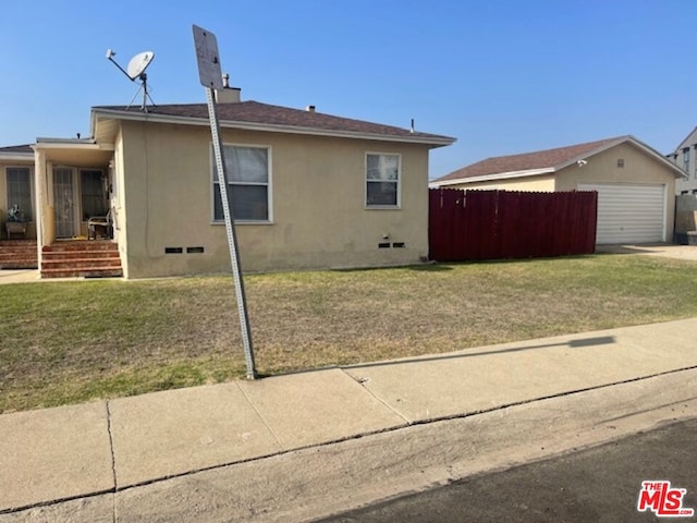 view of side of property featuring a lawn and a garage