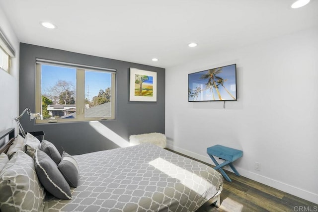 bedroom featuring dark hardwood / wood-style flooring and multiple windows