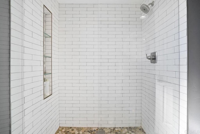 bathroom with tiled shower