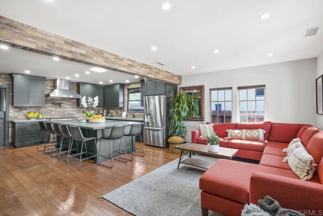 living room featuring light hardwood / wood-style floors and sink