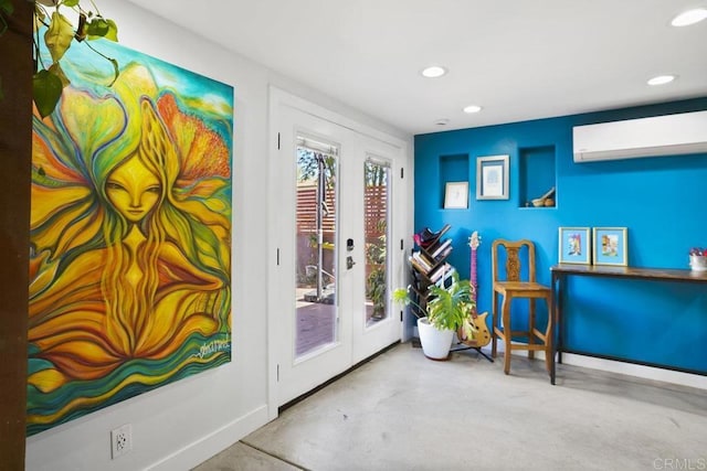 entryway featuring french doors, recessed lighting, a wall mounted air conditioner, concrete floors, and baseboards