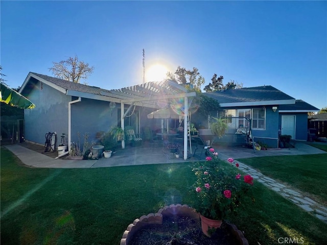 back of property featuring a lawn, a pergola, and a patio area