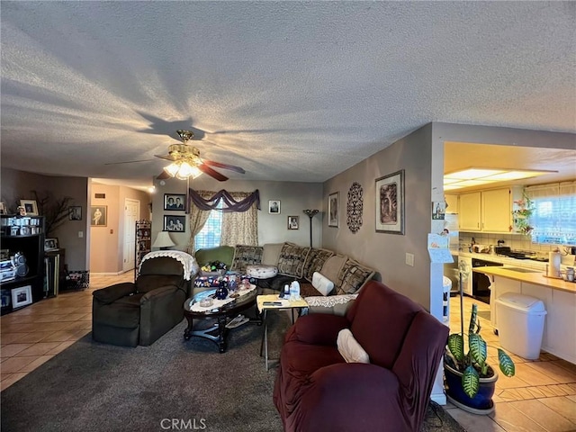 tiled living room featuring ceiling fan and a textured ceiling