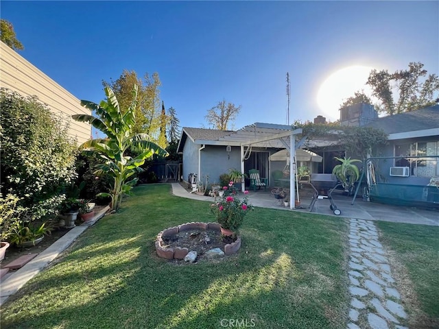 view of yard featuring a pergola, a patio area, cooling unit, and an outdoor fire pit