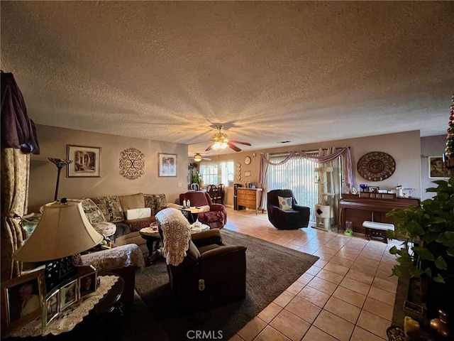 tiled living room featuring a textured ceiling and ceiling fan