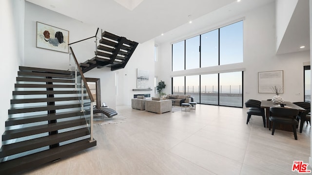 stairs featuring a towering ceiling