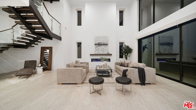 living room featuring hardwood / wood-style flooring and a high ceiling