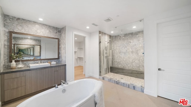 bathroom with vanity and independent shower and bath