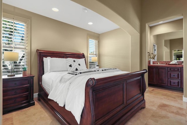 bedroom featuring sink and multiple windows