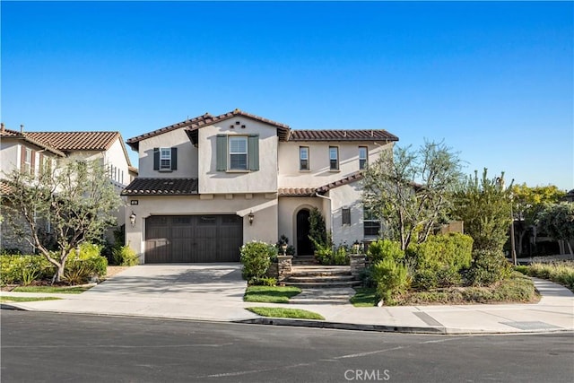 mediterranean / spanish-style home with a garage