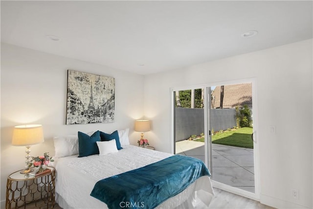 bedroom featuring access to exterior and hardwood / wood-style flooring