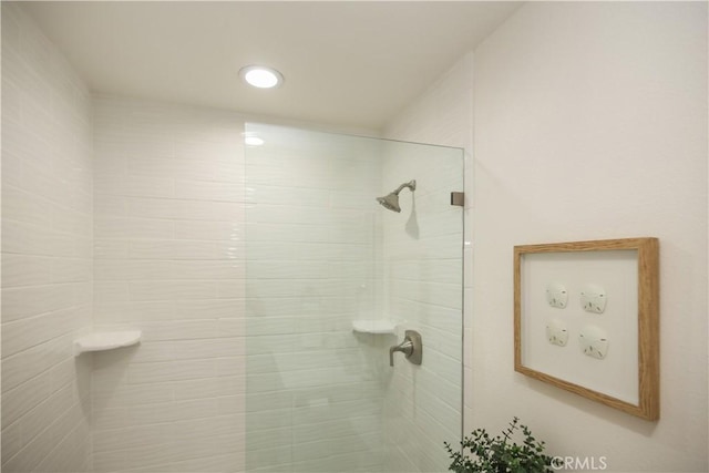 bathroom with tiled shower