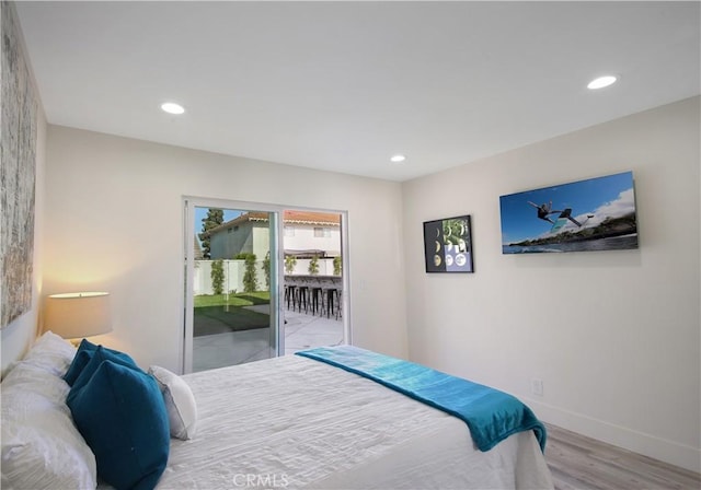 bedroom featuring light wood-type flooring and access to outside