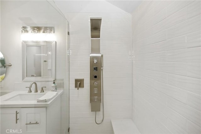 bathroom featuring walk in shower and vanity