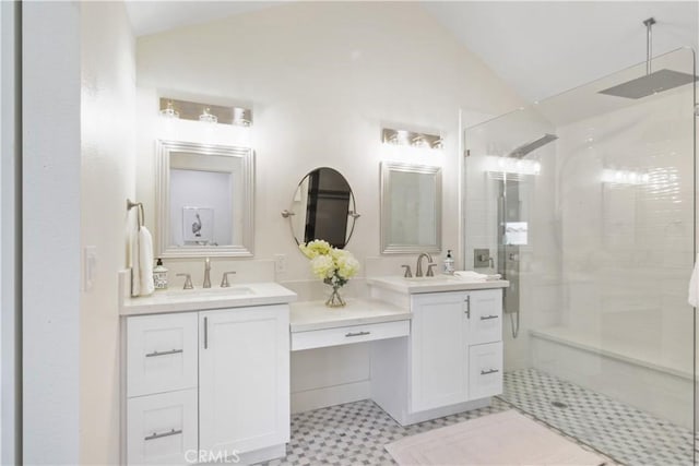 bathroom featuring an enclosed shower, vanity, and vaulted ceiling