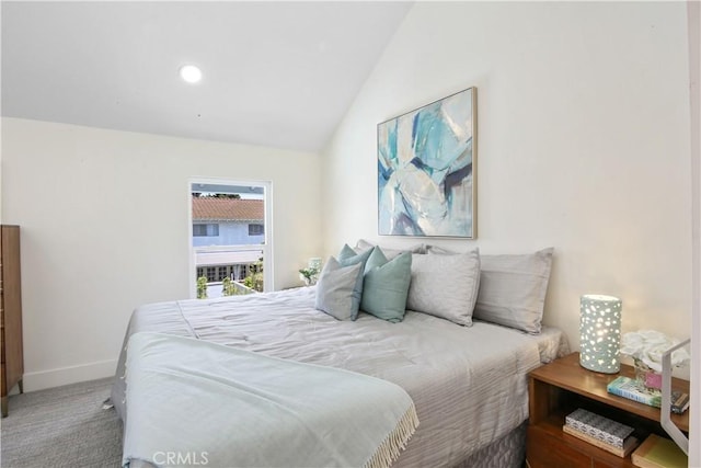 carpeted bedroom with lofted ceiling