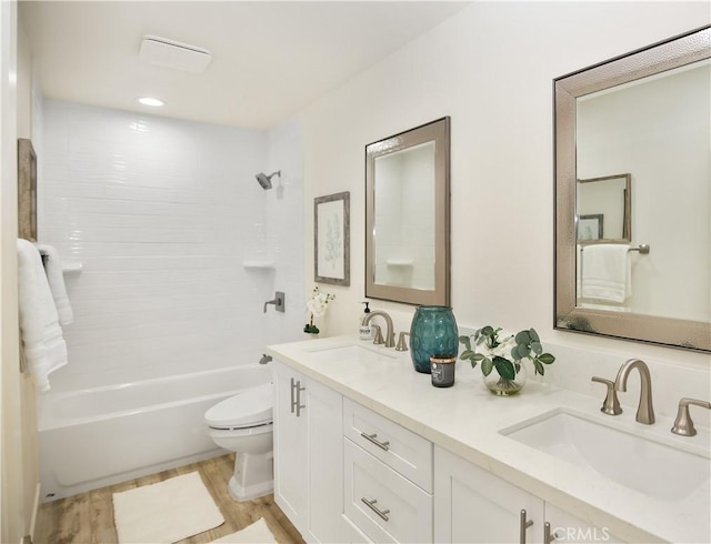 full bathroom with toilet, vanity, wood-type flooring, and shower / bath combination