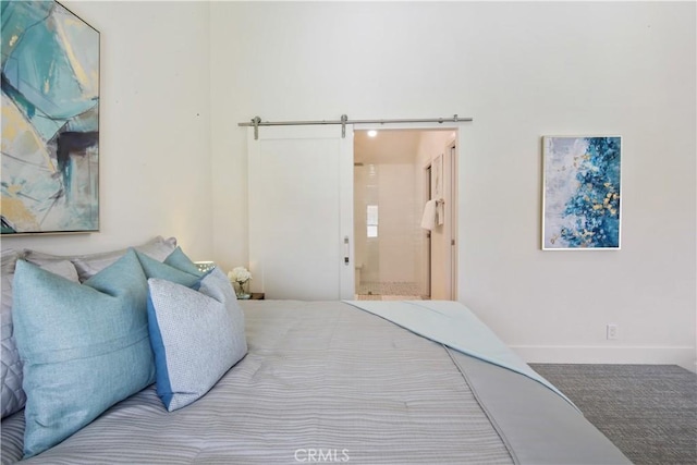 bedroom with a barn door and ensuite bath