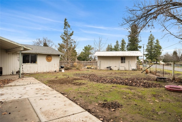 view of yard with an outbuilding and a patio area