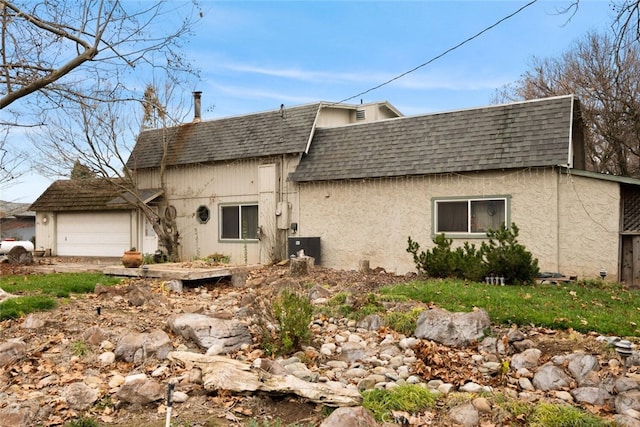 rear view of house with a garage